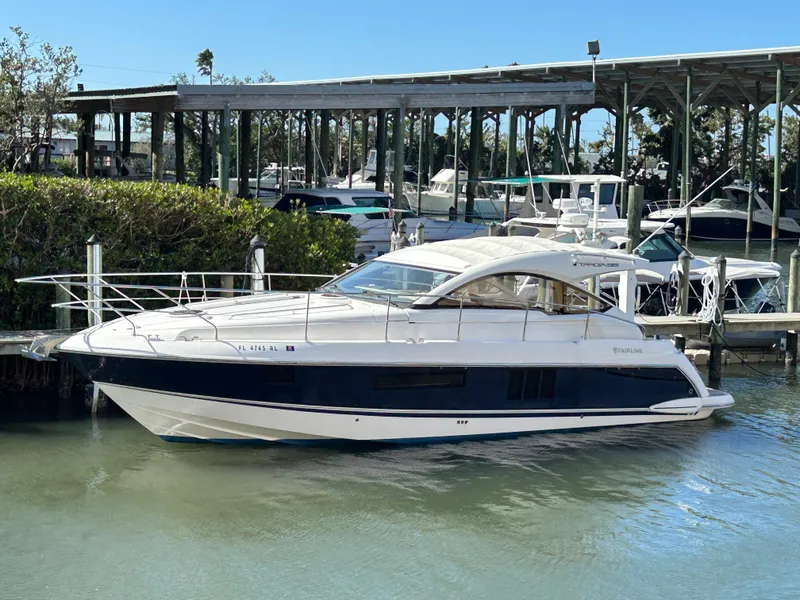 Slide: The Image of 2013 Fairline Targa 38 Open yacht docked in a marina, side view. - 1