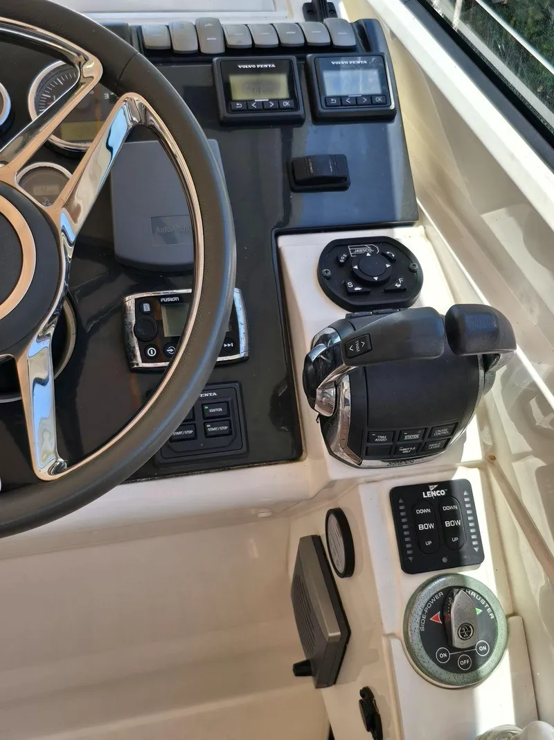 Slide: The Image of Control panel of 2013 Fairline Targa 38 Open yacht with steering wheel and navigation controls. - 18