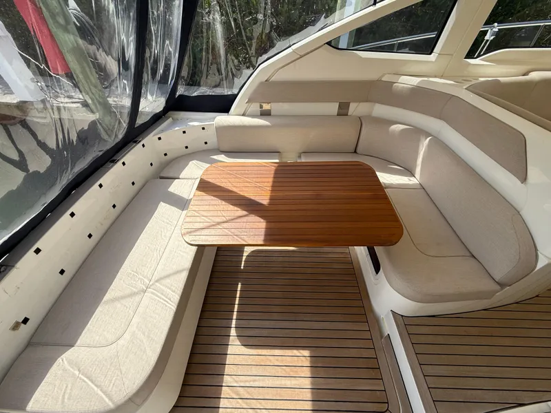 Slide: The Image of 2013 Fairline Targa 38 Open yacht interior with wooden table and beige seating. - 38