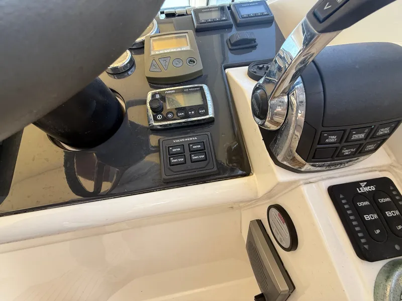 Slide: The Image of Control panel of a 2013 Fairline Targa 38 Open yacht with throttle and navigation instruments. - 47