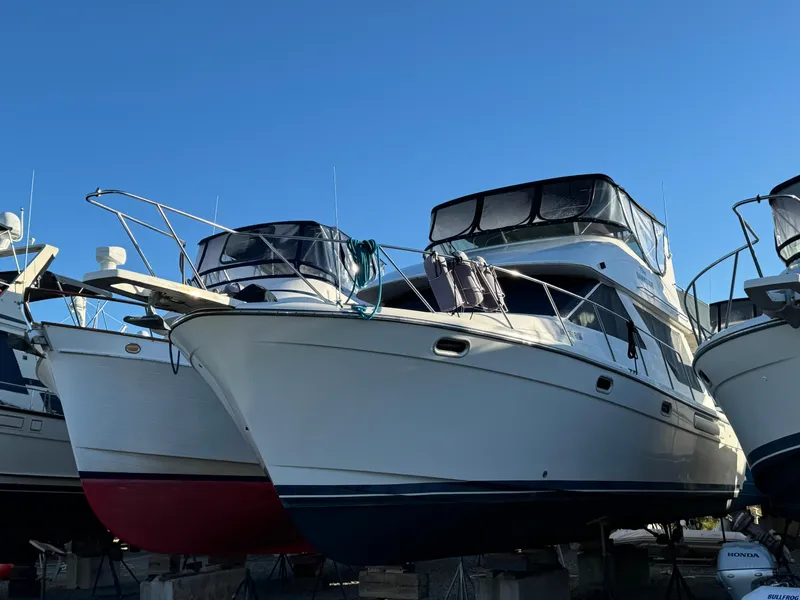 The Image of 2002 Bayliner 39 Motor Yacht on dry dock under clear blue sky. - 0
