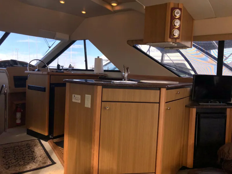 Slide: The Image of Interior of 2002 Bayliner 39 Motor Yacht with wood cabinetry and modern amenities. - 16