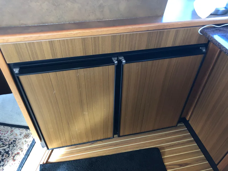 Slide: The Image of Wood-paneled cabinets in 2002 Bayliner 39 Motor Yacht interior. - 20
