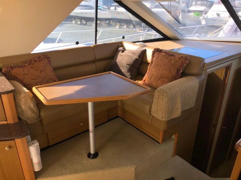Slide: The Image of Interior of 2002 Bayliner 39 Motor Yacht with cozy seating and table. - 21