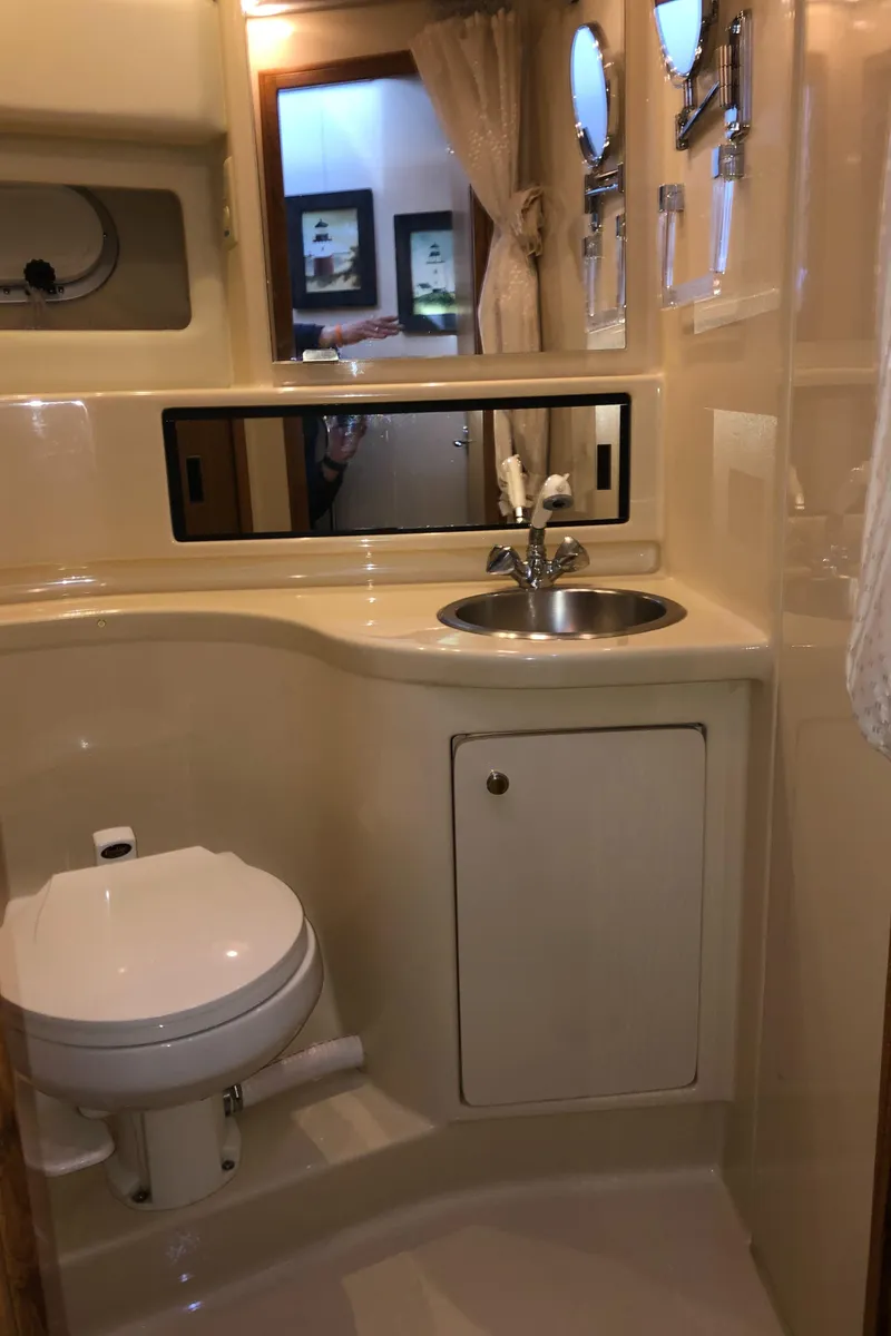 Slide: The Image of 2002 Bayliner 39 Motor Yacht bathroom with sink, toilet, and mirror. - 25