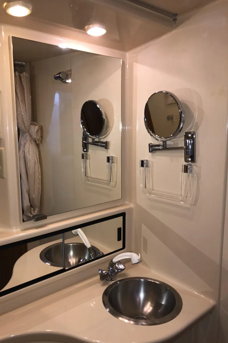 Slide: The Image of 2002 Bayliner 39 Motor Yacht bathroom with mirror, sink, and lighting. - 26