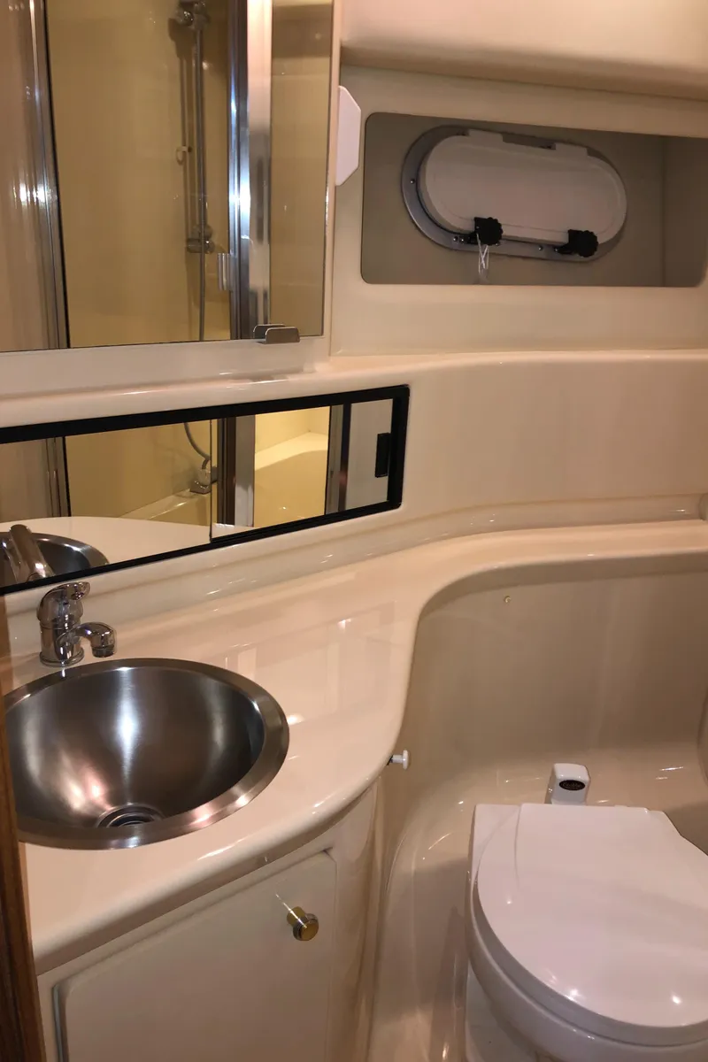 Slide: The Image of 2002 Bayliner 39 Motor Yacht bathroom with sink, toilet, and shower. - 30