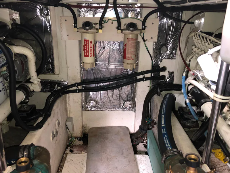 Slide: The Image of Engine room of a 2002 Bayliner 39 Motor Yacht, featuring various hoses and components. - 37