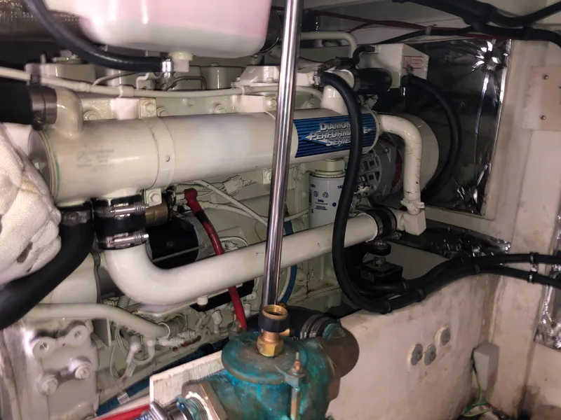 Slide: The Image of Engine room of 2002 Bayliner 39 Motor Yacht, showcasing mechanical components and piping. - 38