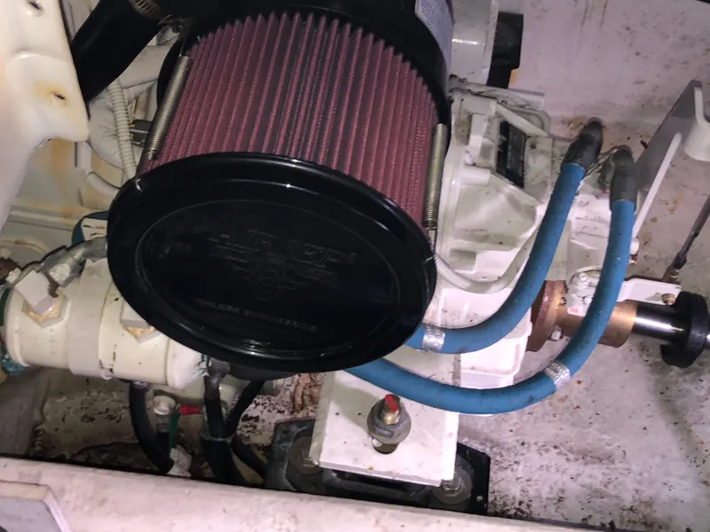 Slide: The Image of Engine compartment of a 2002 Bayliner 39 Motor Yacht with visible air filter and hoses. - 40