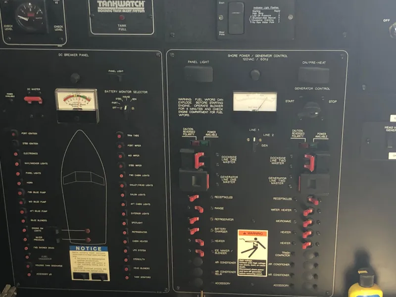 Slide: The Image of Control panel of a 2002 Bayliner 39 Motor Yacht with various switches and indicators. - 43