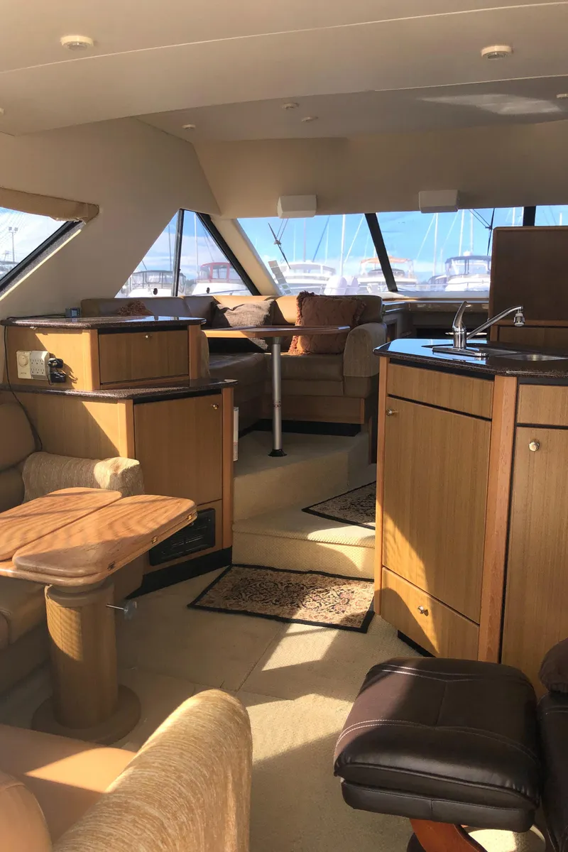 Slide: The Image of Interior of 2002 Bayliner 39 Motor Yacht with modern furnishings and ample natural light. - 9