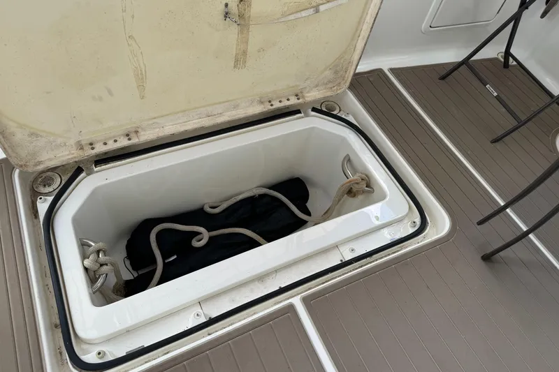 Slide: The Image of Open storage compartment on 2006 Silverton 43 Sport Bridge boat deck. - 11