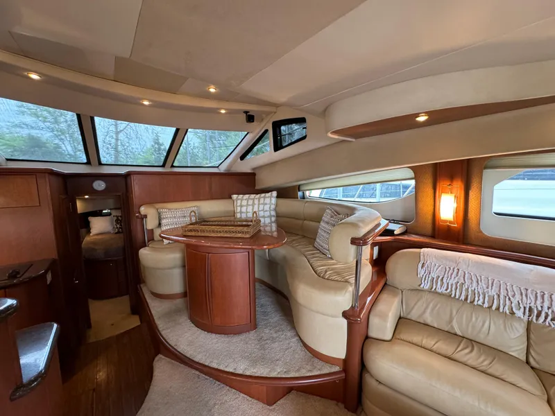 Slide: The Image of Luxurious 2006 Silverton 43 Sport Bridge yacht interior with plush seating and elegant wood finishes. - 16