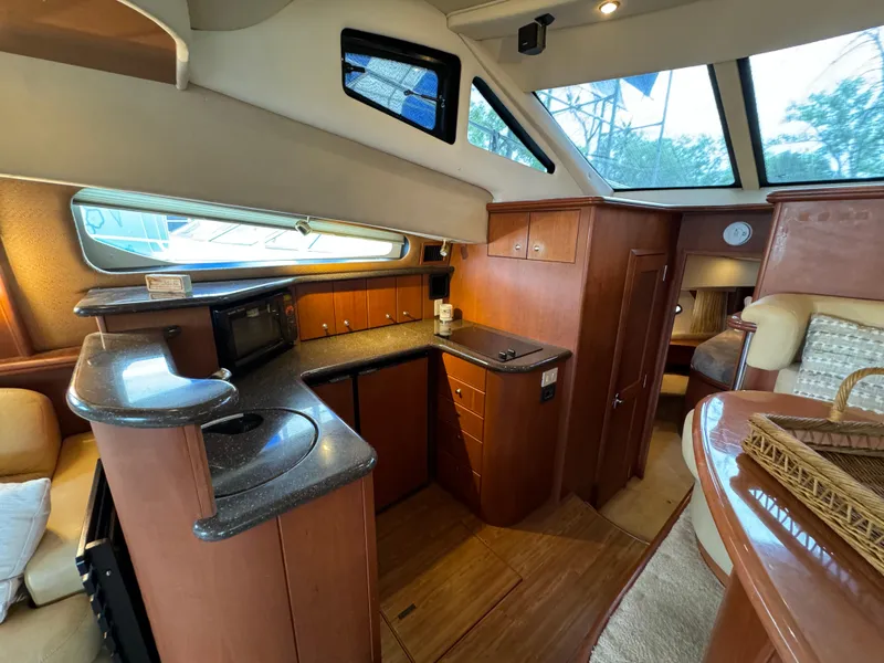 Slide: The Image of Interior of 2006 Silverton 43 Sport Bridge yacht with modern kitchen and seating area. - 18