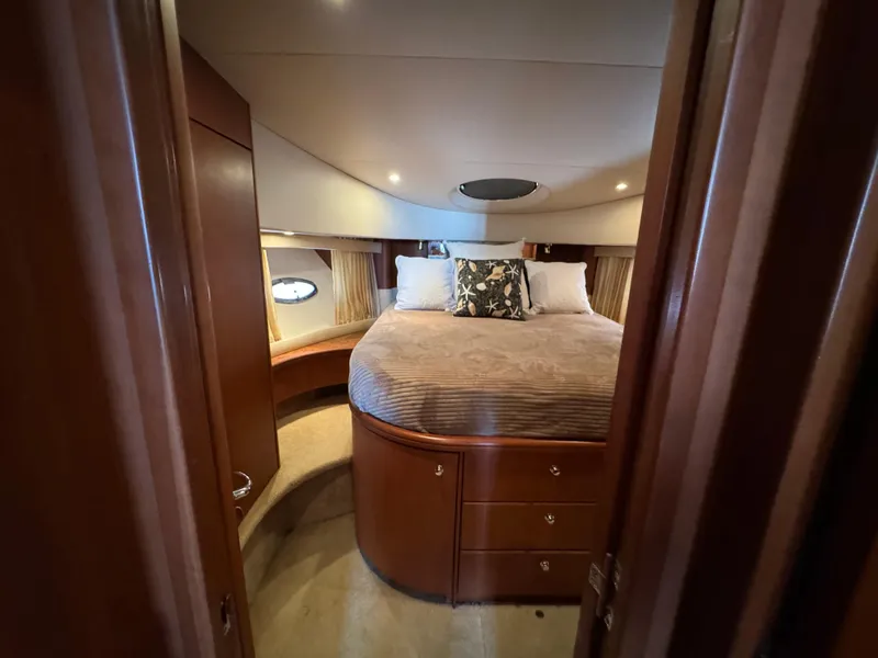 Slide: The Image of Luxurious bedroom interior of 2006 Silverton 43 Sport Bridge yacht with cozy bed and wood finish. - 22
