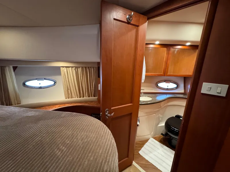Slide: The Image of Luxurious interior of 2006 Silverton 43 Sport Bridge yacht with wood finishes and porthole windows. - 25