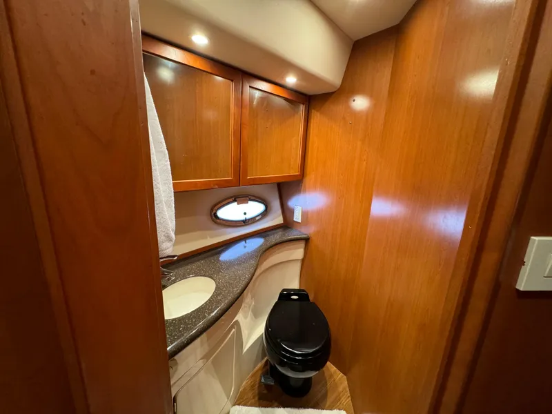 Slide: The Image of Luxurious 2006 Silverton 43 Sport Bridge yacht bathroom with wood cabinetry and modern fixtures. - 26
