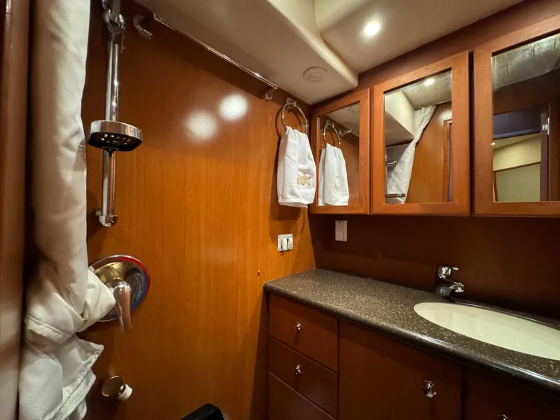 Slide: The Image of Luxurious bathroom in 2006 Silverton 43 Sport Bridge yacht with wood cabinetry and modern fixtures. - 34