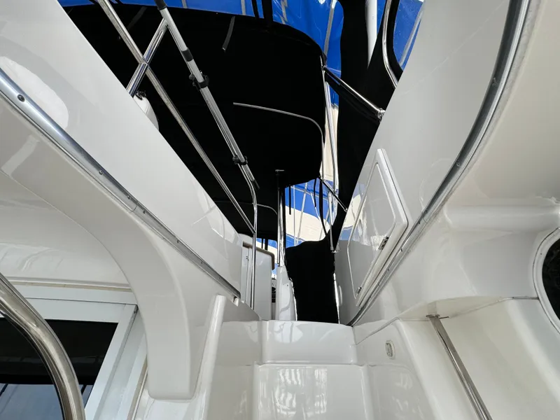 Slide: The Image of 2006 Silverton 43 Sport Bridge yacht interior with sleek white design and stainless steel railings. - 36