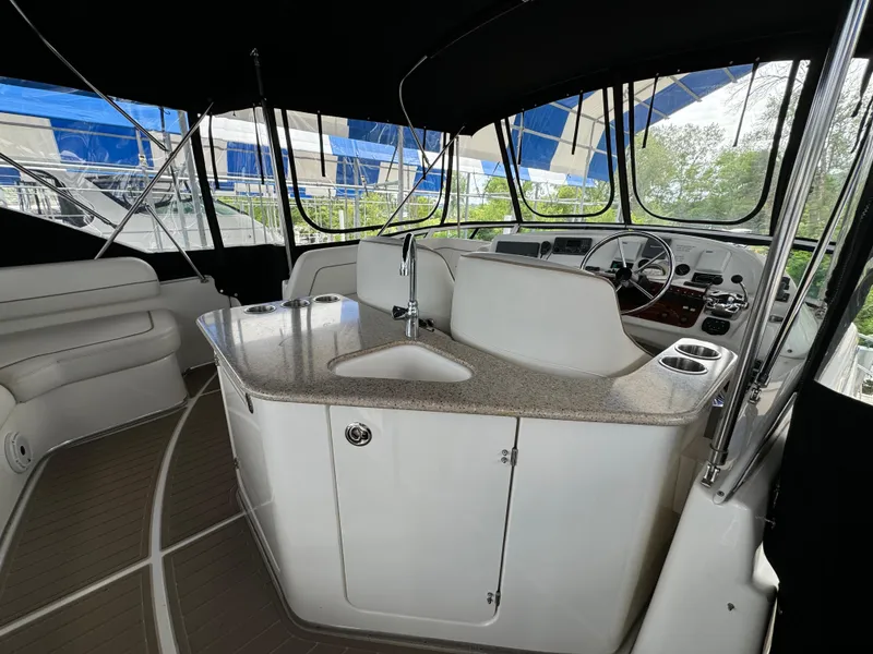 Slide: The Image of 2006 Silverton 43 Sport Bridge interior with helm, seating, and counter. - 39