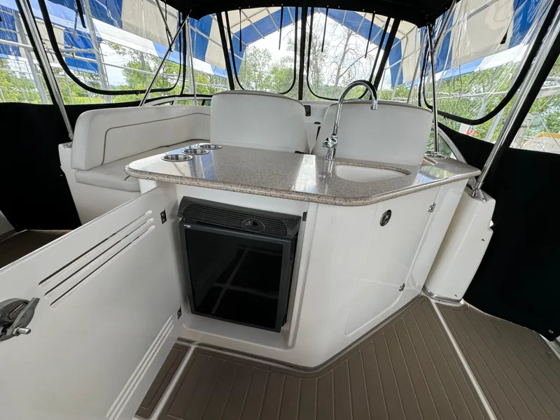 Slide: The Image of 2006 Silverton 43 Sport Bridge interior with kitchenette, featuring sink and mini-fridge. - 40