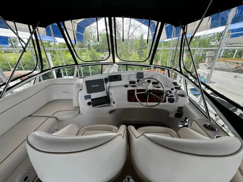Slide: The Image of 2006 Silverton 43 Sport Bridge helm with modern controls and panoramic view. - 42
