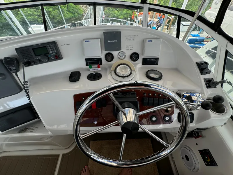 Slide: The Image of Helm of 2006 Silverton 43 Sport Bridge with steering wheel and navigation controls. - 43