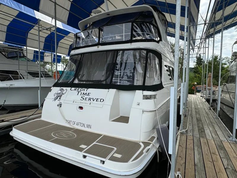 Slide: The Image of 2006 Silverton 43 Sport Bridge yacht docked under a blue and white canopy. - 5