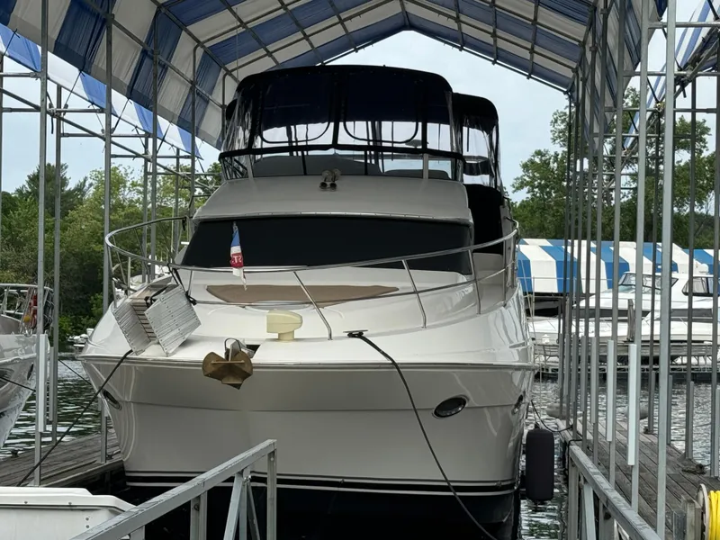Slide: The Image of 2006 Silverton 43 Sport Bridge yacht docked under a covered marina. - 7