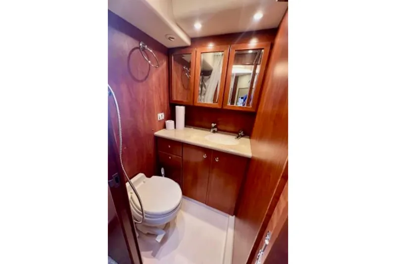 Slide: The Image of Luxurious bathroom in 2006 Silverton 43 Sport Bridge yacht with wood cabinetry and modern fixtures. - 73