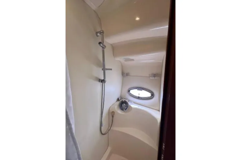Slide: The Image of Shower area in 2006 Silverton 43 Sport Bridge yacht with porthole window. - 74