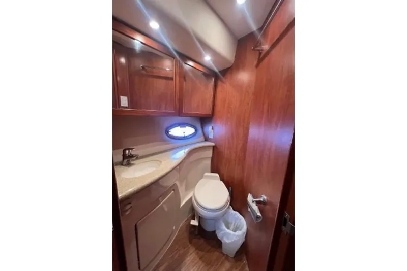 Slide: The Image of Luxurious bathroom in 2006 Silverton 43 Sport Bridge yacht with wood cabinetry and modern fixtures. - 75