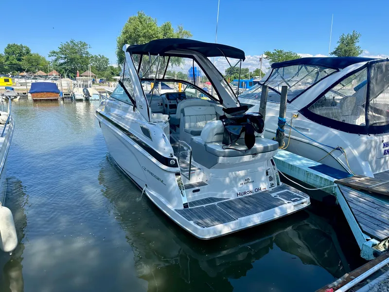 Slide: The Image of 2022 Regal 28 Express boat docked in a marina under clear blue skies. - 2