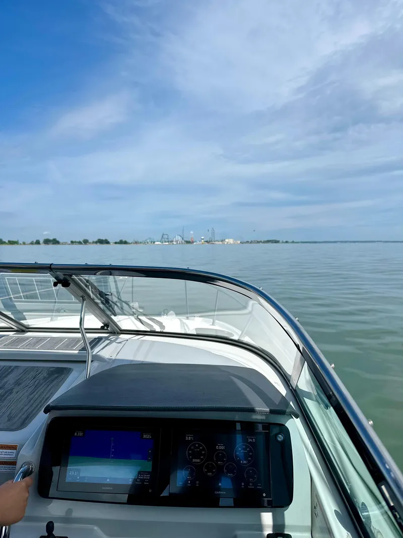 Slide: The Image of 2022 Regal 28 Express boat dashboard with scenic water view. - 4