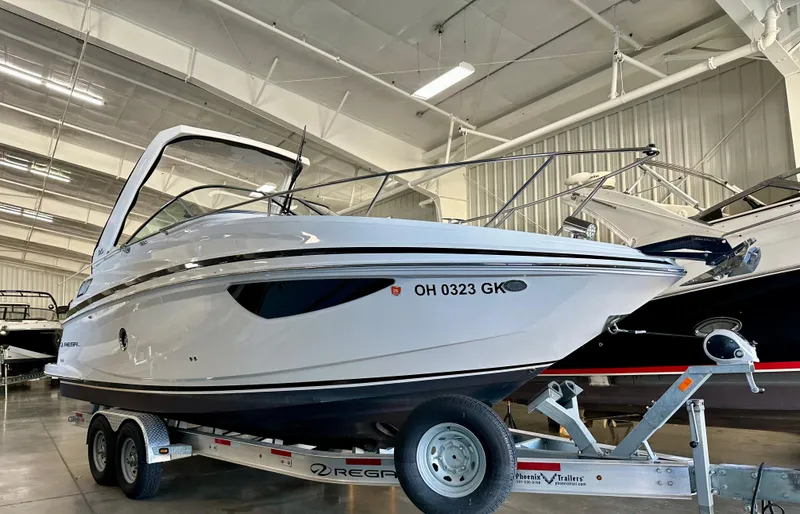 Slide: The Image of 2022 Regal 28 Express boat on trailer in indoor showroom. - 5