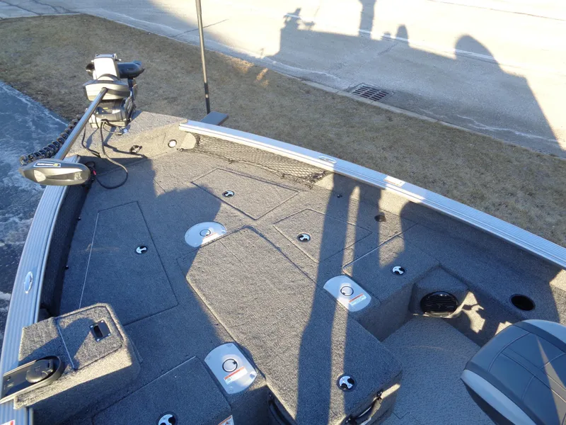 Slide: The Image of 2025 Lund 1875 Pro Guide boat interior with fishing rod holders and storage compartments. - 15