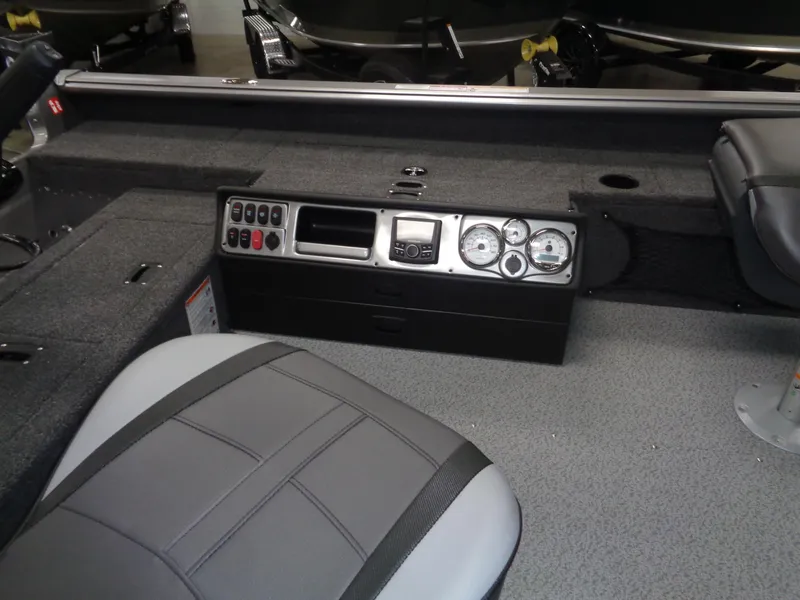 Slide: The Image of 2025 Lund 1875 Pro Guide boat interior with control panel and seating. - 31