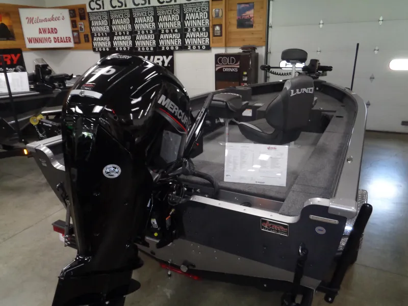 Slide: The Image of 2025 Lund 1875 Pro Guide boat with Mercury engine in showroom. - 32