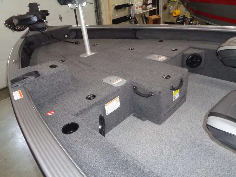 Slide: The Image of 2025 Lund 1875 Pro Guide boat interior with storage compartments and seating. - 36