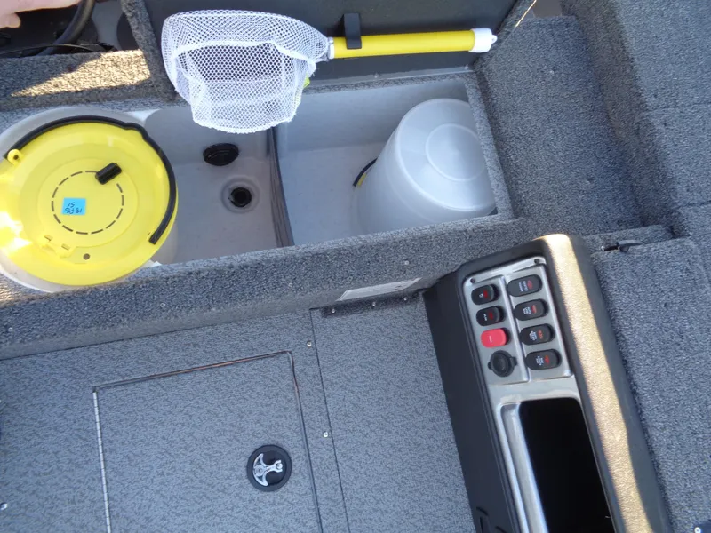 Slide: The Image of Interior view of 2025 Lund 1875 Pro Guide boat with storage compartments and control panel. - 43