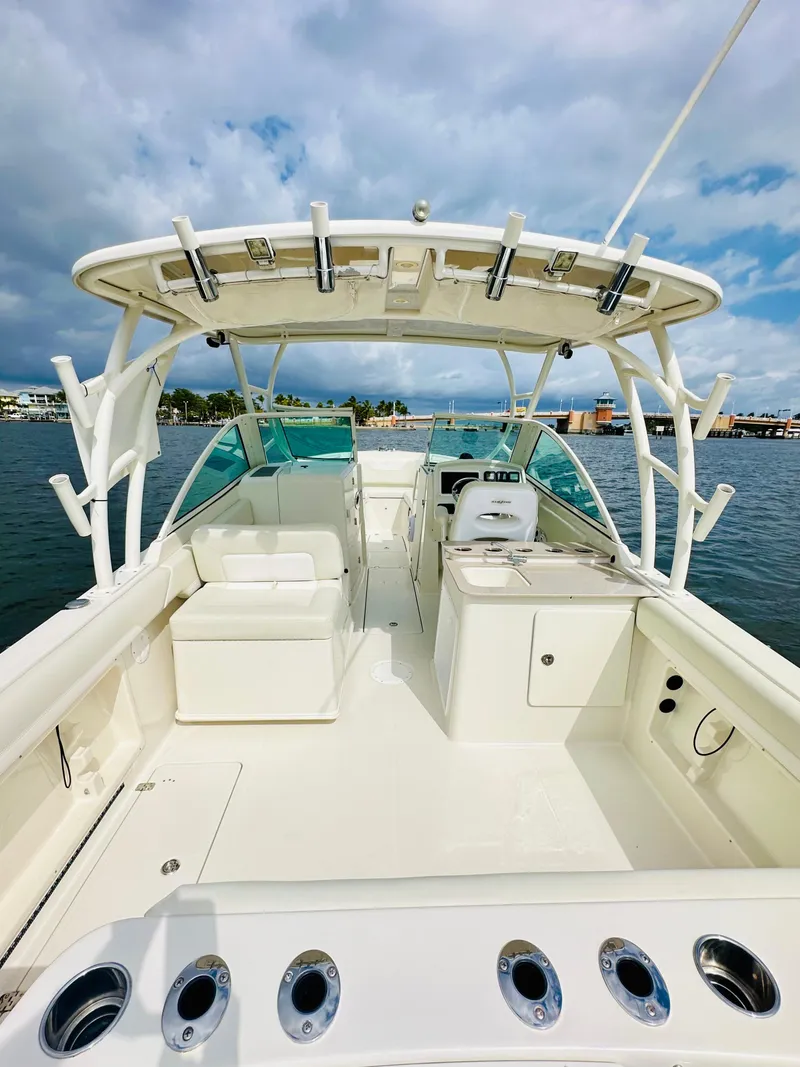 Slide: The Image of 2014 Sailfish 275 DC boat interior with seating and fishing rod holders. - 10