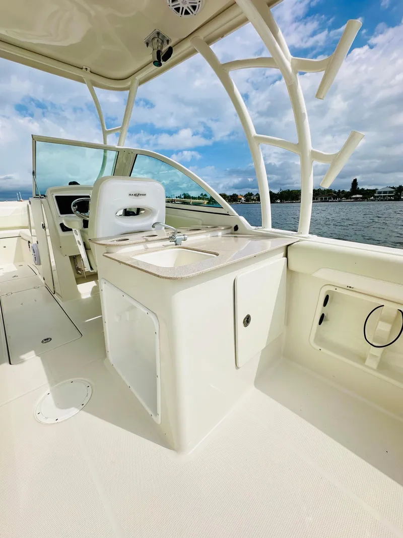 Slide: The Image of 2014 Sailfish 275 DC boat interior with helm, seating, and ocean view. - 12