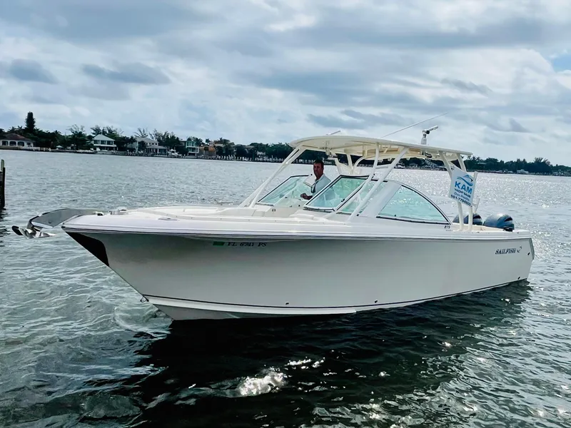 Slide: The Image of 2014 Sailfish 275 DC boat on calm water under cloudy sky. - 2