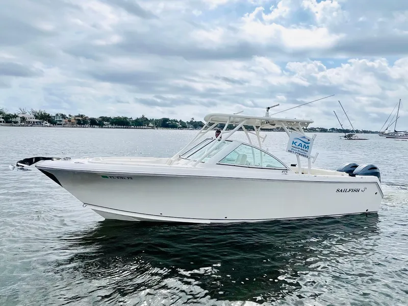 Slide: The Image of 2014 Sailfish 275 DC boat on calm water under cloudy sky. - 3