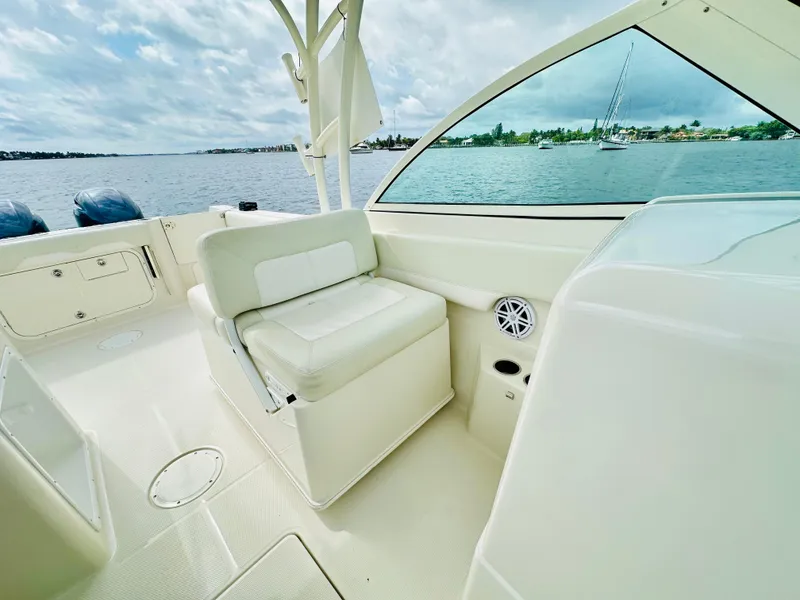 Slide: The Image of 2014 Sailfish 275 DC boat interior with seating, overlooking calm waters. - 5