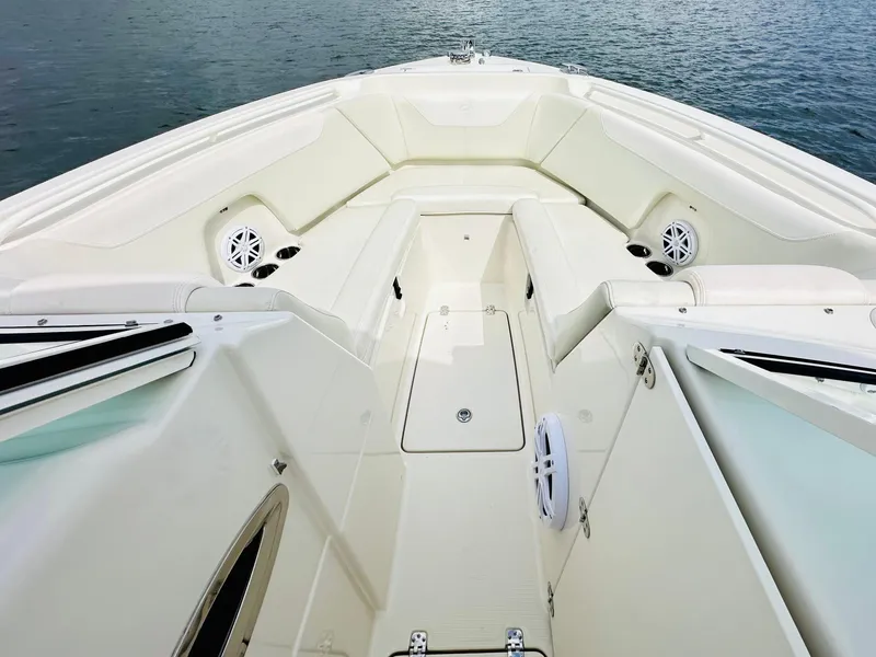 Slide: The Image of 2014 Sailfish 275 DC boat interior with spacious seating and speakers. - 8