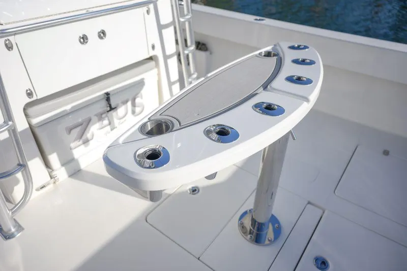 Slide: The Image of 2022 SeaVee 390Z boat deck with rod holders and storage compartment. - 11