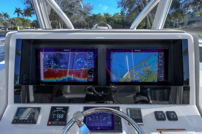 Slide: The Image of 2022 SeaVee 390Z helm with dual navigation screens and controls. - 16