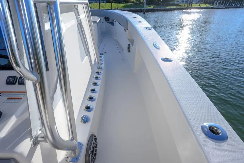 Slide: The Image of 2022 SeaVee 390Z boat deck with stainless steel railings by the water. - 19